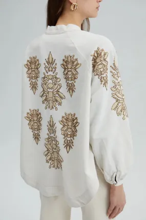 Off-white kimono jacket with shiny embroidery in earthy browns.